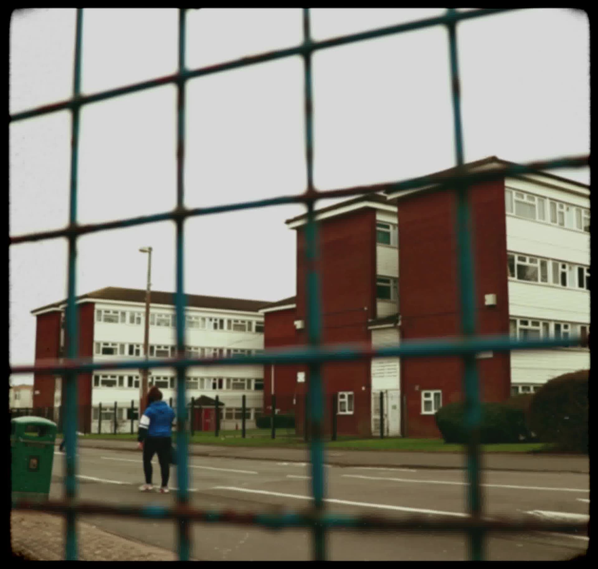 Vintage, film-like photography style with muted colors, soft focus, heavy grain, and black rounded borders, evoking a nostalgic, documentary feel.